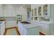 Bright and spacious kitchen with white cabinets, granite countertops, and a large center island at 418 W Carolina Ave, Summerville, SC 29483