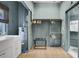 Bright laundry room featuring a sink, water heater, and a spacious closet with ample hanging space at 418 W Carolina Ave, Summerville, SC 29483