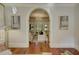 Elegant living area featuring hardwood floors and an archway, seamlessly connecting to a sunlit area at 418 W Carolina Ave, Summerville, SC 29483