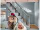 Cozy living room featuring a staircase, comfortable seating, hardwood floors, and decor at 418 W Carolina Ave, Summerville, SC 29483