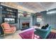Comfortable living room with wood floors, a fireplace, and custom built-in shelving at 418 W Carolina Ave, Summerville, SC 29483