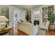 Cozy living room with fireplace, hardwood floors, bookshelves, and white furniture at 418 W Carolina Ave, Summerville, SC 29483