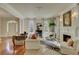 Bright living room features a fireplace, hardwood floors, and comfortable seating for relaxation and entertainment at 418 W Carolina Ave, Summerville, SC 29483