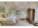 Main bedroom featuring a luxurious bed, neutral tones, and bright, natural light at 418 W Carolina Ave, Summerville, SC 29483