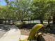 A park with a bench in the shape of a banana peel with a tennis court in the background at 418 W Carolina Ave, Summerville, SC 29483