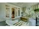 Comfortable screened porch featuring wicker furniture, a swing, and views of the lush greenery at 418 W Carolina Ave, Summerville, SC 29483