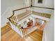 Elegant staircase with wood treads and white railing leading to a well-lit foyer area at 418 W Carolina Ave, Summerville, SC 29483
