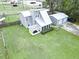 Aerial view of a house with a large yard, gray siding and a detached garage at 49 Auld Brass Rd, Walterboro, SC 29488