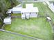 An aerial view of the home showcasing the large fenced yard, storage shed, and metal roof at 49 Auld Brass Rd, Walterboro, SC 29488