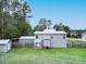 A view of the backyard featuring a large yard, privacy fence, and back exterior of the home at 49 Auld Brass Rd, Walterboro, SC 29488