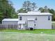 A view of the backyard featuring a large yard, privacy fence, and back exterior of the home at 49 Auld Brass Rd, Walterboro, SC 29488