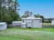 A view of the backyard featuring a large yard, privacy fence, and back exterior of the home at 49 Auld Brass Rd, Walterboro, SC 29488