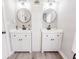Bathroom featuring dual vanity with round mirrors, and white cabinets at 49 Auld Brass Rd, Walterboro, SC 29488