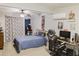 Personalized bedroom with gaming setup, study area, fan, and comfortable bedding for relaxing at 49 Auld Brass Rd, Walterboro, SC 29488