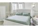 Inviting bedroom features soft color palette, paneling, comfortable bedding, and ample natural light at 49 Auld Brass Rd, Walterboro, SC 29488