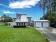 Charming gray two-story home with a metal roof and a detached two car garage at 49 Auld Brass Rd, Walterboro, SC 29488