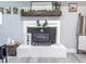 Cozy fireplace with a white brick surround, decorated with a wood mantel and Gathering photos at 49 Auld Brass Rd, Walterboro, SC 29488
