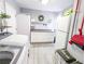 Functional laundry room with granite countertops, appliances, white cabinets, and decorative accents at 49 Auld Brass Rd, Walterboro, SC 29488