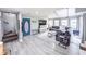 Open-concept living room with a gray sofa, large windows, and modern decor at 49 Auld Brass Rd, Walterboro, SC 29488