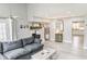 Bright and airy living room with a gray sofa, fireplace, and neutral decor at 49 Auld Brass Rd, Walterboro, SC 29488