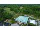 Aerial view of club house with green roof nestled amongst a scenic golf course and lush trees at 5022 W Liberty Meadows Dr, Summerville, SC 29485
