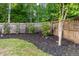 Landscaped backyard with a wood fence surrounding the perimeter for privacy at 5022 W Liberty Meadows Dr, Summerville, SC 29485