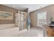 Bright bathroom featuring a soaking tub, glass-enclosed shower, and marble floors at 5022 W Liberty Meadows Dr, Summerville, SC 29485