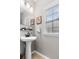 Cozy bathroom with a pedestal sink, framed art, and lots of natural light at 5022 W Liberty Meadows Dr, Summerville, SC 29485