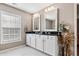 Bathroom featuring double sinks with black countertops and white cabinetry at 5022 W Liberty Meadows Dr, Summerville, SC 29485