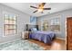 Cozy bedroom features hardwood floors, a ceiling fan, and two windows offering plenty of natural light at 5022 W Liberty Meadows Dr, Summerville, SC 29485