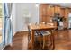 Cozy dining area with wood table, matching chairs, hardwood floors, and natural light from the window at 5022 W Liberty Meadows Dr, Summerville, SC 29485