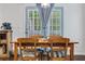 Cozy dining area with a wooden table, chairs, and a view of the backyard through the glass door at 5022 W Liberty Meadows Dr, Summerville, SC 29485