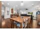 Open concept dining area with hardwood floors, a kitchen bar, and views into the living room at 5022 W Liberty Meadows Dr, Summerville, SC 29485