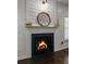 Elegant fireplace with wood mantel, decor, and hardwood floors at 5022 W Liberty Meadows Dr, Summerville, SC 29485