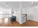 Upstairs hallway with hardwood floors and a comfortable sitting area, leading to other rooms in the home at 5022 W Liberty Meadows Dr, Summerville, SC 29485