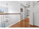 Bright hallway with hardwood floors and white walls, featuring a chandelier and access to several rooms at 5022 W Liberty Meadows Dr, Summerville, SC 29485