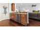 Kitchen island with a stainless steel dishwasher, granite countertop, and view of the living room at 5022 W Liberty Meadows Dr, Summerville, SC 29485