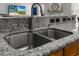 Close-up of the kitchen sink with granite countertops, stainless steel faucet, and undermount sink at 5022 W Liberty Meadows Dr, Summerville, SC 29485