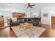 Cozy living room with plush sectional sofa, patterned rug, ceiling fan, and hardwood floors at 5022 W Liberty Meadows Dr, Summerville, SC 29485