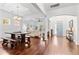 Open concept living area featuring hardwood floors, coffered ceiling, and an abundance of natural light at 5022 W Liberty Meadows Dr, Summerville, SC 29485