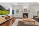 Cozy living room with fireplace, comfortable seating, and hardwood floors at 5022 W Liberty Meadows Dr, Summerville, SC 29485