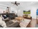 Relaxing living room with gray sectional, hardwood floors, and media center at 5022 W Liberty Meadows Dr, Summerville, SC 29485