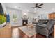 Spacious living room featuring a cozy fireplace, comfortable seating, and hardwood floors at 5022 W Liberty Meadows Dr, Summerville, SC 29485