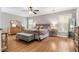Comfortable main bedroom with hardwood floors, a large bed, and ample natural light from the windows at 5022 W Liberty Meadows Dr, Summerville, SC 29485