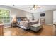 Well-lit main bedroom showcasing hardwood floors, ample natural light, and tastefully decorated furnishings at 5022 W Liberty Meadows Dr, Summerville, SC 29485