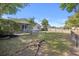 Large grassy fenced backyard with mature trees, screened porch at 527 Hainsworth Dr, Charleston, SC 29414