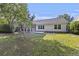 Spacious, fenced backyard with a screened in porch and a lawn at 527 Hainsworth Dr, Charleston, SC 29414