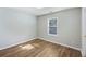 Well-lit bedroom with laminate flooring, window with blinds, and ample space at 527 Hainsworth Dr, Charleston, SC 29414