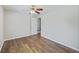 Neutral bedroom with hardwood flooring, a ceiling fan, and a doorway to another room at 527 Hainsworth Dr, Charleston, SC 29414