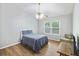 Cozy bedroom with hardwood floors, ceiling fan, and a bright window at 527 Hainsworth Dr, Charleston, SC 29414
